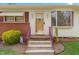 Inviting front entrance with a decorative door, brick accents, and manicured landscaping at 1315 Elder Way, Burlington, NC 27215