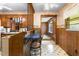 Cozy kitchen with wood cabinets, a breakfast bar, and classic patterned flooring at 1315 Elder Way, Burlington, NC 27215