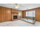 Charming living room with brick fireplace, railing, and a bright bay window at 1315 Elder Way, Burlington, NC 27215