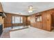 View of the living room with a bay window, brick fireplace, and paneled walls at 1315 Elder Way, Burlington, NC 27215