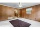 Spacious living room with wood paneled walls, a ceiling fan, and plush carpet at 1315 Elder Way, Burlington, NC 27215
