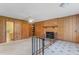 Spacious living room with a brick fireplace, unique railings, and paneled walls at 1315 Elder Way, Burlington, NC 27215