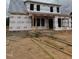 Unfinished home with brick and Hardie board awaiting completion with exposed 2x4 studs at 1327 Parkertown Rd, Four Oaks, NC 27524