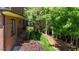 Exterior brick wall featuring a beautiful green lawn with mature trees at 145 Cofield Cir, Durham, NC 27707