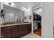 Elegant bathroom featuring double sinks, granite countertops, and walk-in closet access at 145 Cofield Cir, Durham, NC 27707
