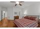 Comfortable bedroom with hardwood floors, a decorative bedspread, and abundant natural light at 145 Cofield Cir, Durham, NC 27707
