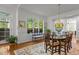 Elegant dining room with natural light, hardwood floors, and decorative rug at 145 Cofield Cir, Durham, NC 27707