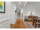 Elegant entryway boasts hardwood floors, staircase, and dining area with sophisticated decor at 145 Cofield Cir, Durham, NC 27707