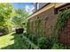 Brick house exterior features lush greenery, brick wall with vines, and manicured lawn at 145 Cofield Cir, Durham, NC 27707