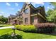 Attractive brick home with well-kept lawn, flowering shrubs, and an attached two-car garage at 145 Cofield Cir, Durham, NC 27707