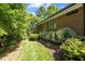 Brick home exterior with lush landscaping and a well-maintained grassy area at 145 Cofield Cir, Durham, NC 27707