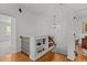 Bright hallway featuring hardwood floors, display shelving, and wrought iron railing at 145 Cofield Cir, Durham, NC 27707