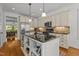 Stylish kitchen with stainless steel appliances, large island, and adjacent breakfast nook at 145 Cofield Cir, Durham, NC 27707