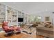 Spacious living room with built-in bookshelves, comfortable seating, and ample natural light at 145 Cofield Cir, Durham, NC 27707