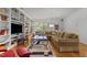 Large living room featuring custom shelving, a comfortable sofa, and a decorative rug at 145 Cofield Cir, Durham, NC 27707