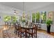 Open living room with large windows, fireplace, hardwood floors, and classic furniture at 145 Cofield Cir, Durham, NC 27707