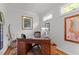 Charming home office with a wood desk, and natural light from two windows at 145 Cofield Cir, Durham, NC 27707