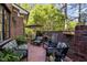 Cozy brick patio with comfortable seating, potted plants, and an umbrella table at 145 Cofield Cir, Durham, NC 27707