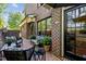 Charming brick patio with outdoor seating, lush plants, and access to the home interior at 145 Cofield Cir, Durham, NC 27707