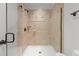 Elegant walk-in shower with glass door, neutral tile, and a built-in shower head at 145 Cofield Cir, Durham, NC 27707