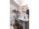 Charming bathroom featuring a pedestal sink and unique seashell-framed mirror at 1512 St. Mary'S St, Raleigh, NC 27608
