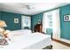 Inviting bedroom featuring two twin beds, teal walls, white curtains, and natural light at 1512 St. Mary'S St, Raleigh, NC 27608