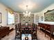 Elegant dining room with a large table, decorative wallpaper, and built-in shelving at 1512 St. Mary'S St, Raleigh, NC 27608