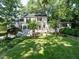 Stately white home with lush front yard and mature trees providing shade at 1512 St. Mary'S St, Raleigh, NC 27608