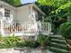 Charming home exterior featuring a lovely porch with stone steps and lush greenery at 1512 St. Mary'S St, Raleigh, NC 27608