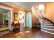 Spacious foyer with hardwood floors, staircase, and classic architectural details at 1512 St. Mary'S St, Raleigh, NC 27608
