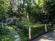 Picturesque garden featuring raised beds, lush plants, and a decorative fence at 1512 St. Mary'S St, Raleigh, NC 27608