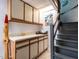 Hallway featuring built-in cabinets, countertop, and staircase with gray railings at 1512 St. Mary'S St, Raleigh, NC 27608
