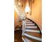 Elegant curved staircase featuring hardwood steps and a decorative railing at 1512 St. Mary'S St, Raleigh, NC 27608