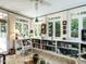 Bright sunroom boasts built-in bookshelves, comfortable seating, and multiple windows offering serene outdoor views at 1512 St. Mary'S St, Raleigh, NC 27608