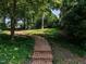 Scenic backyard pathway lined with lush greenery and mature trees at 1512 St. Mary'S St, Raleigh, NC 27608