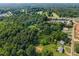 Wide angle aerial view of the community surrounded by lush green trees at 163 Lake Latham Rd, Mebane, NC 27302