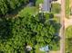 Aerial view of property with wooded lot and nearby road at 163 Lake Latham Rd, Mebane, NC 27302
