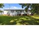Back of home featuring small deck and steps down to grassy backyard at 163 Lake Latham Rd, Mebane, NC 27302