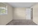 Bright bedroom featuring neutral carpet, walls, and window letting in natural light at 163 Lake Latham Rd, Mebane, NC 27302