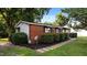 Landscaped exterior with brick and siding, manicured shrubs, and walkway at 163 Lake Latham Rd, Mebane, NC 27302
