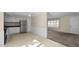 Bright kitchen featuring white cabinetry, stainless steel refrigerator, and view into the living room at 163 Lake Latham Rd, Mebane, NC 27302