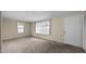 Cozy living room with neutral carpet, featuring a large window with blinds and plenty of wall space at 163 Lake Latham Rd, Mebane, NC 27302