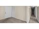 Spacious living room transitioning to a hallway, featuring neutral carpet and a closeted door at 163 Lake Latham Rd, Mebane, NC 27302