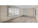 Inviting living room featuring plush carpeting, large window, and view into the hallway with lots of natural light at 163 Lake Latham Rd, Mebane, NC 27302