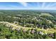 Scenic aerial view showcases the neighborhood with lush landscaping and mature trees at 164 Avocet Ln, Clayton, NC 27520