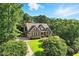 Stunning aerial view of brick home with lush green lawn and mature trees at 164 Avocet Ln, Clayton, NC 27520