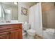 Cozy bathroom featuring cherry wood vanity with a mirror, toilet, and shower with curtain at 164 Avocet Ln, Clayton, NC 27520