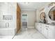 Luxurious bathroom with marble floors, double vanities, wooden sauna, and glass shower at 164 Avocet Ln, Clayton, NC 27520