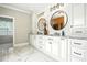 Bright bathroom with double vanities, stylish mirrors, and elegant white marble flooring at 164 Avocet Ln, Clayton, NC 27520