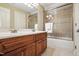 Bathroom with a wooden vanity, double sinks, and a shower with glass door at 164 Avocet Ln, Clayton, NC 27520